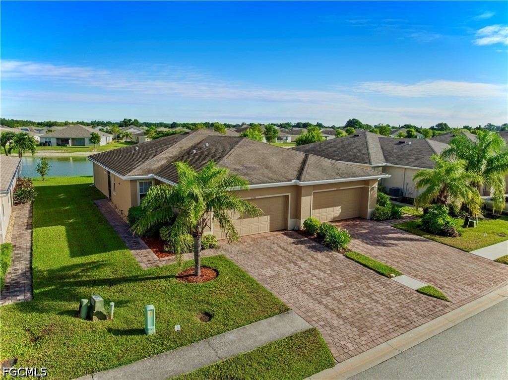 10781 Crossback Lane Lehigh Acres, FL 33974 - Photo 2 of 28 an aerial view of a house with green space and city view