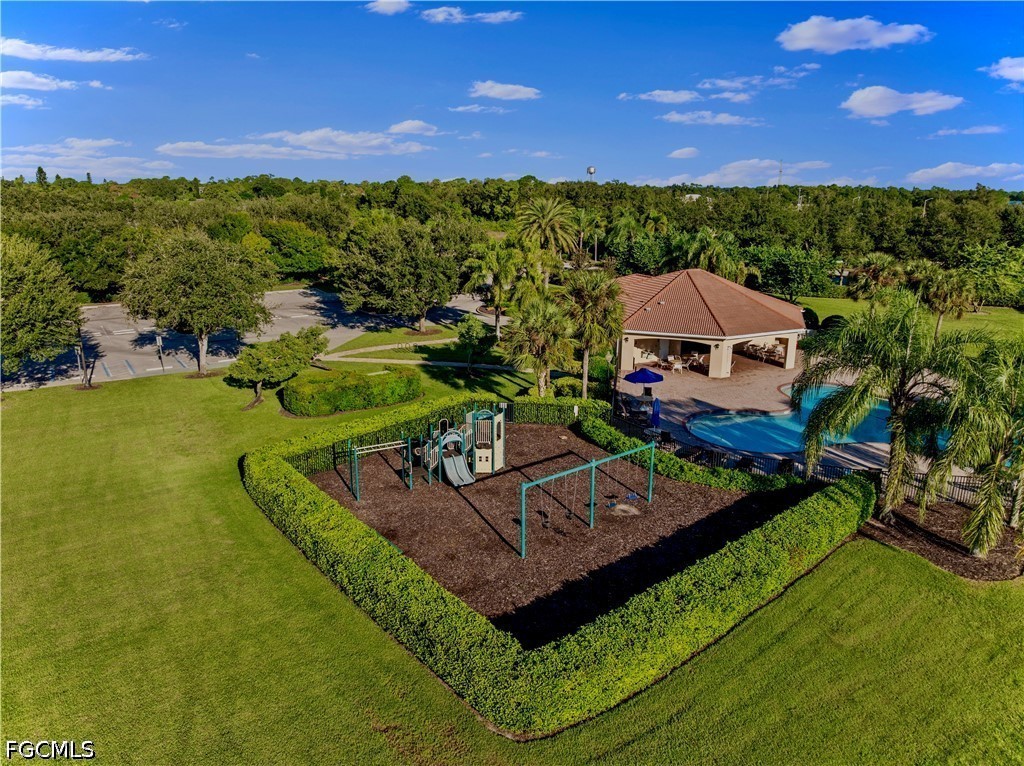 10781 Crossback Lane Lehigh Acres, FL 33974 - Photo 21 of 28 a view of a swimming pool with lawn chairs