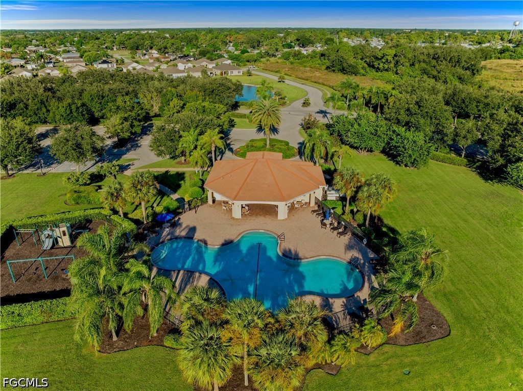 10781 Crossback Lane Lehigh Acres, FL 33974 - Photo 22 of 28 a view of a lake with a house