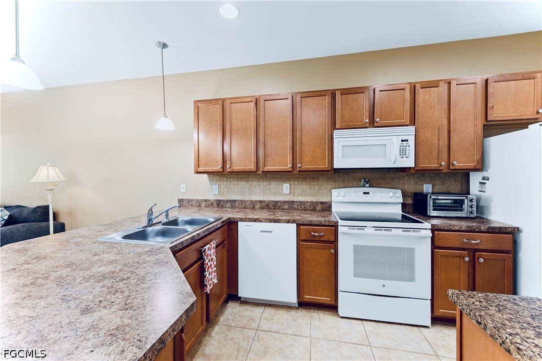 10781 Crossback Lane Lehigh Acres, FL 33974 - Photo 6 of 28 a kitchen with a stove sink and cabinets
