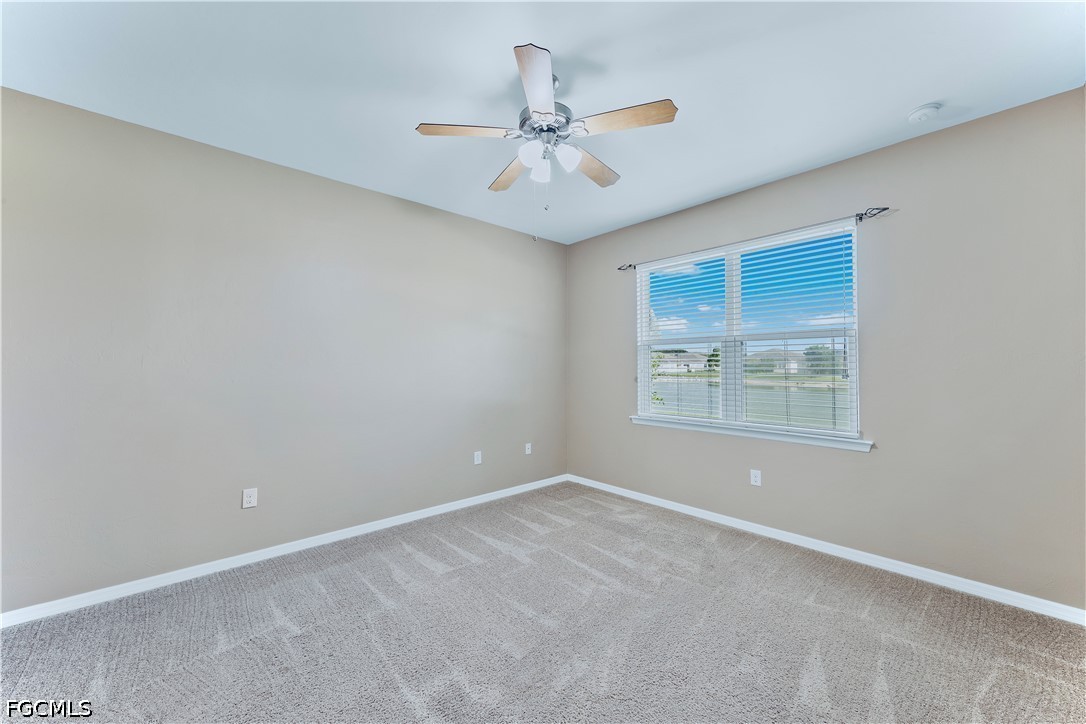 10781 Crossback Lane Lehigh Acres, FL 33974 - Photo 10 of 28 an empty room with a ceiling fan and window