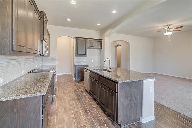 20008 Navarre Terrace Pflugerville, TX 78660 - Photo 4 of 18 a kitchen with granite countertop a sink cabinets and stainless steel appliances
