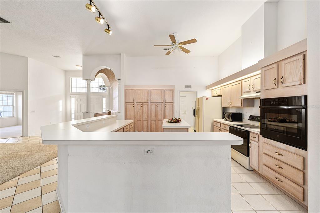 11621 Southwest 72nd Circle Ocala, FL 34476 - Photo 17 of 66 a kitchen with stainless steel appliances kitchen island granite countertop a sink and cabinets