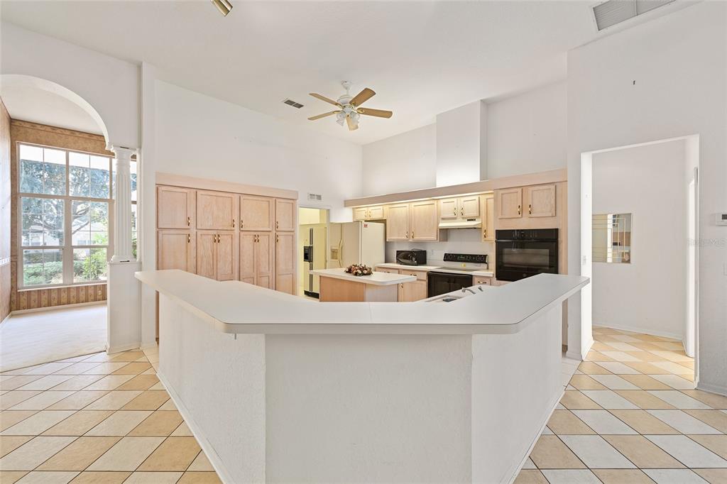 11621 Southwest 72nd Circle Ocala, FL 34476 - Photo 18 of 66 a large white kitchen with a large window