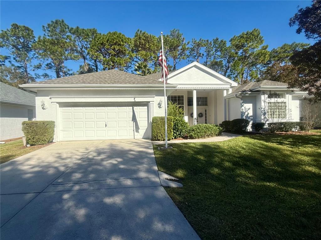 11621 Southwest 72nd Circle Ocala, FL 34476 - Photo 2 of 66 a front view of a house with a yard and garage