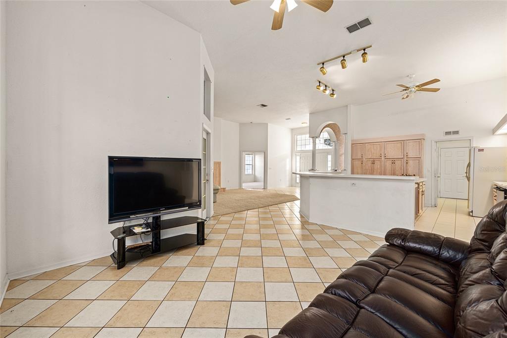 11621 Southwest 72nd Circle Ocala, FL 34476 - Photo 22 of 66 a living room with furniture and a flat screen tv