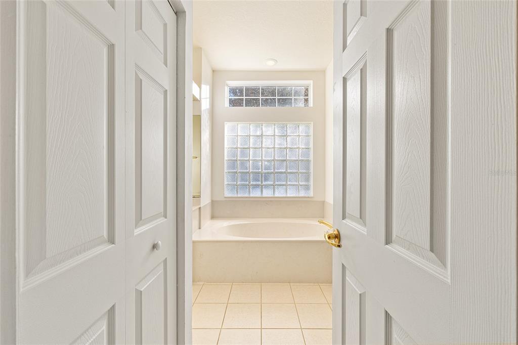 11621 Southwest 72nd Circle Ocala, FL 34476 - Photo 32 of 66 a bathroom with a bathtub and a shower
