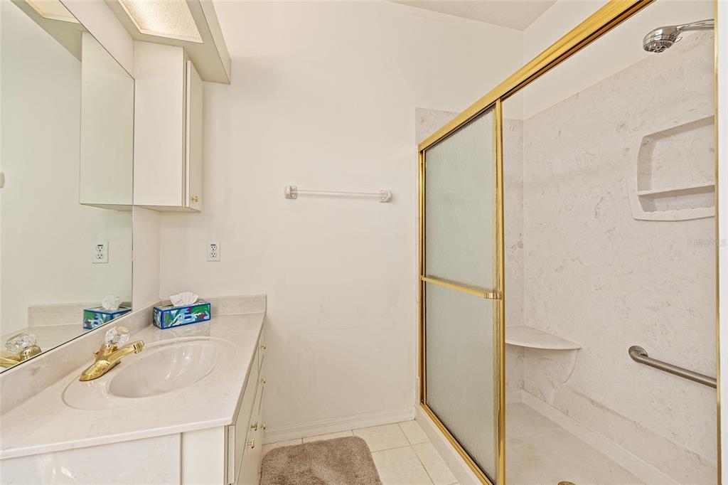 11621 Southwest 72nd Circle Ocala, FL 34476 - Photo 35 of 66 a bathroom with a tub sink and a shower
