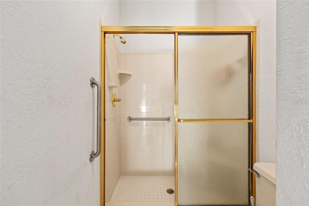 11621 Southwest 72nd Circle Ocala, FL 34476 - Photo 42 of 66 a bathroom with a glass shower door