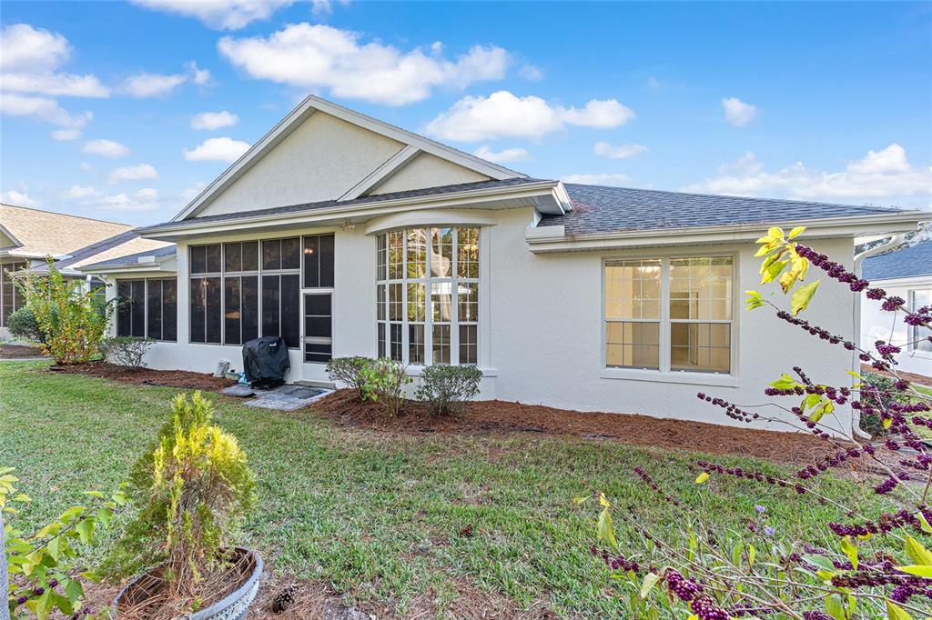 11621 Southwest 72nd Circle Ocala, FL 34476 - Photo 48 of 66 a view of a house with sitting area and garden