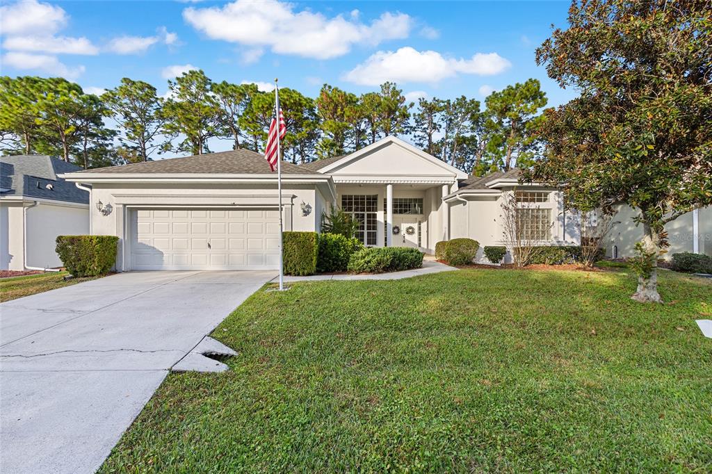11621 Southwest 72nd Circle Ocala, FL 34476 - Photo 5 of 66 a front view of a house with a garden and plants