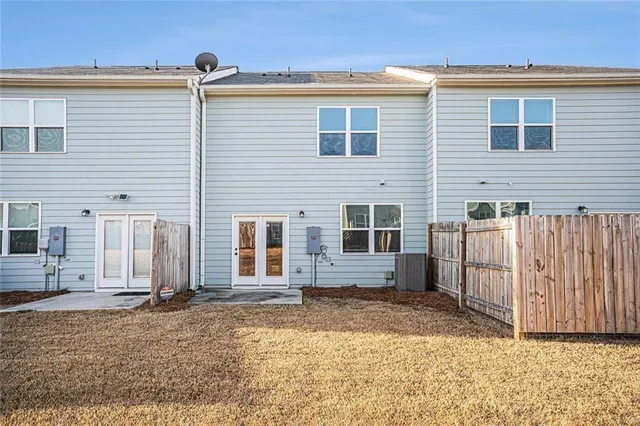 a view of a house with wooden fence