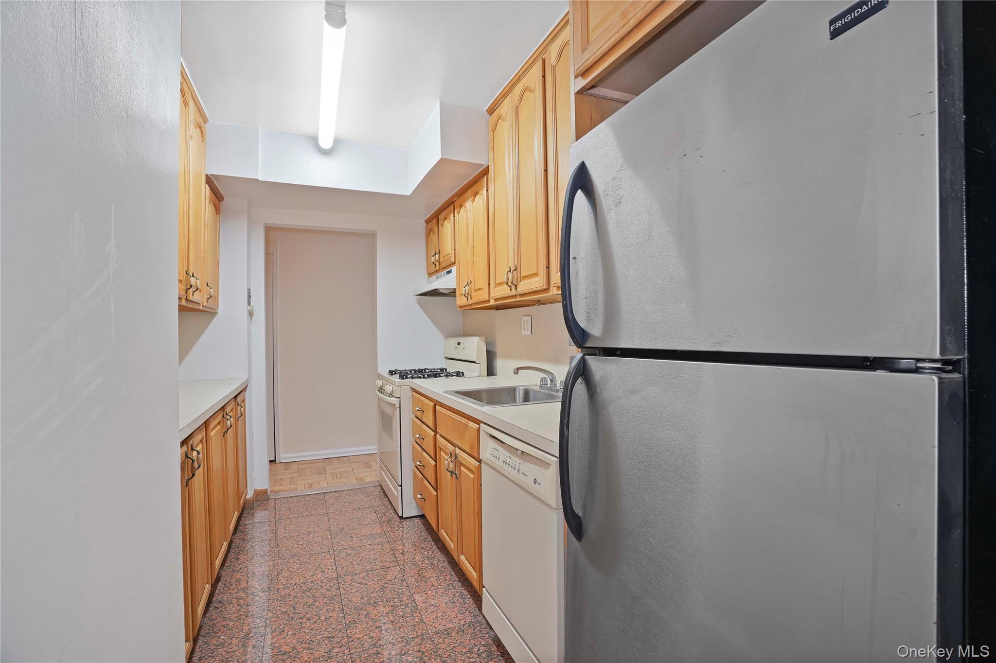 151-31 88th Street, Unit 1B Queens, NY 11414 - Photo 11 of 24 a kitchen with a stove a refrigerator and a sink