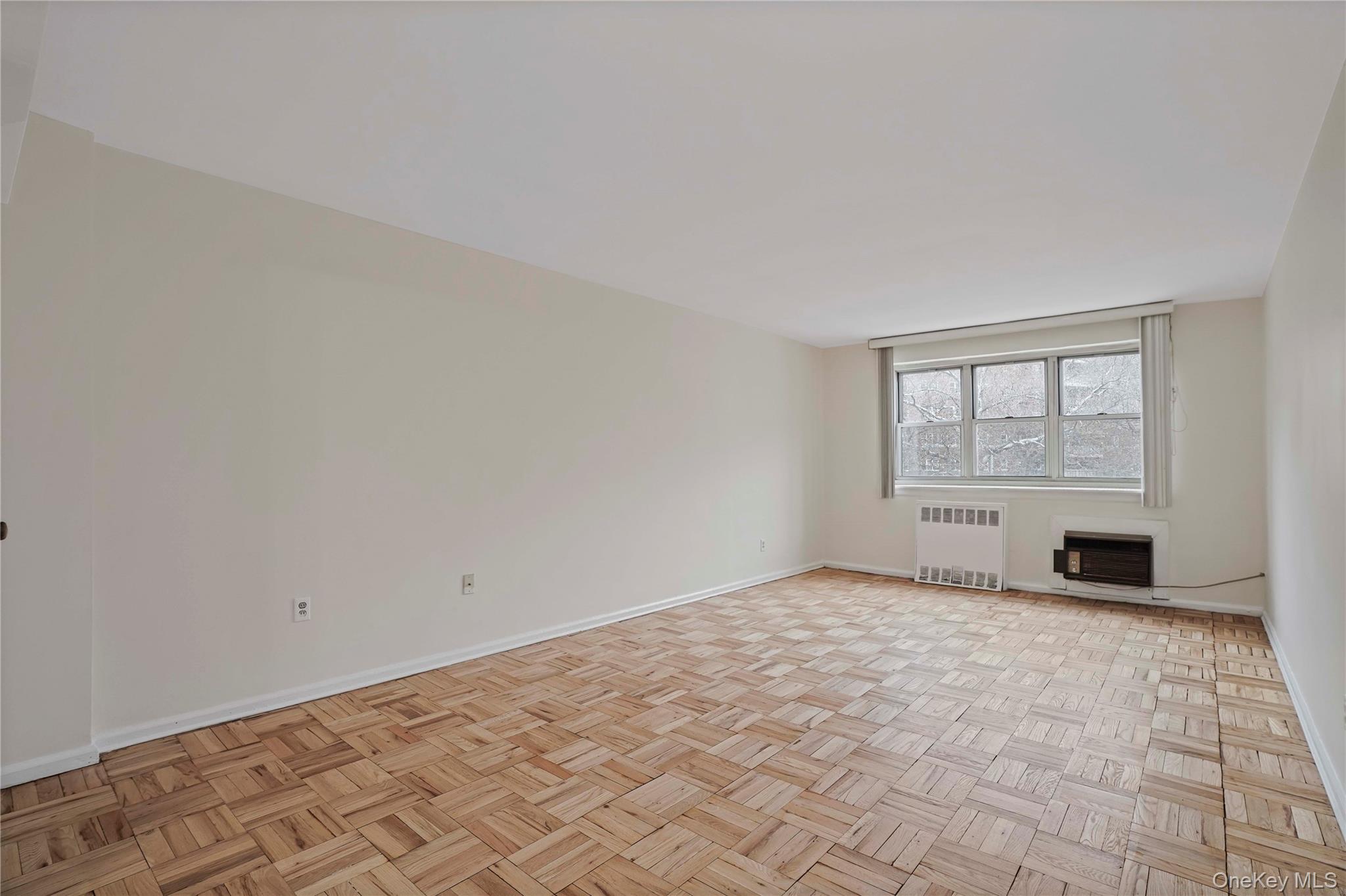 151-31 88th Street, Unit 1B Queens, NY 11414 - Photo 5 of 24 an empty room with windows