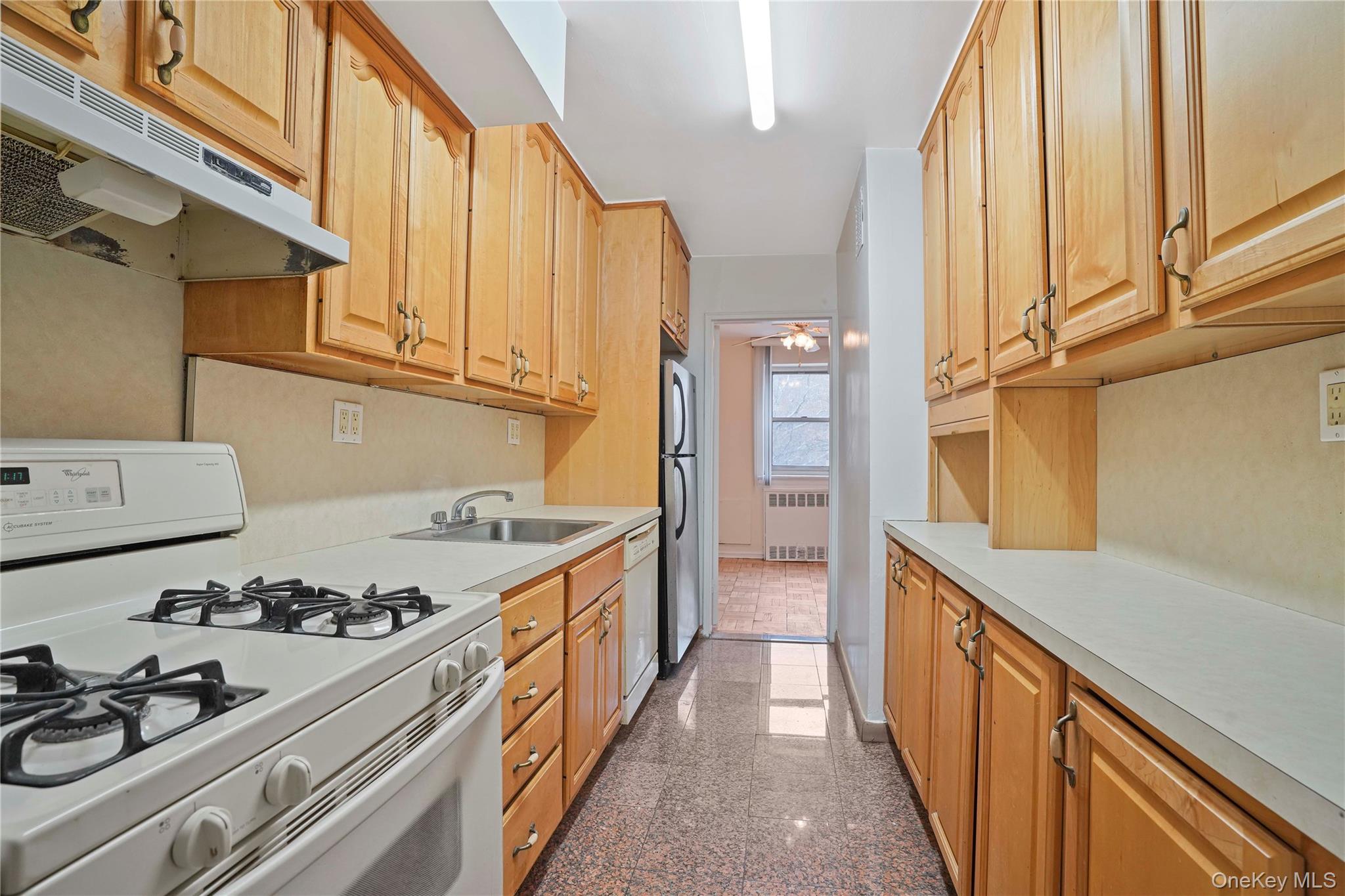 151-31 88th Street, Unit 1B Queens, NY 11414 - Photo 9 of 24 a kitchen with a stove a sink and a refrigerator