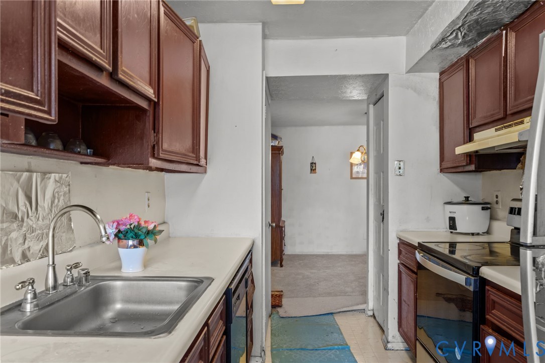 1503 Largo Road, Unit 201 Richmond, VA 23238 - Photo 26 of 37 a kitchen with stainless steel appliances granite countertop a sink stove and refrigerator