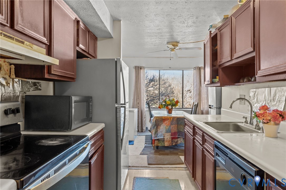 1503 Largo Road, Unit 201 Richmond, VA 23238 - Photo 27 of 37 a kitchen with stainless steel appliances a stove a sink and a refrigerator