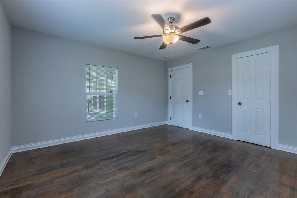 2816 Summer Avenue Waco, TX 76708 - Photo 8 of 16 an empty room with wooden floor chandelier fan and windows