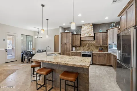 a large kitchen with a table and chairs