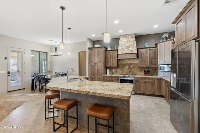 a large kitchen with a table and chairs
