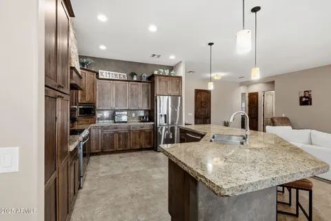 a kitchen with kitchen island a sink stove and refrigerator