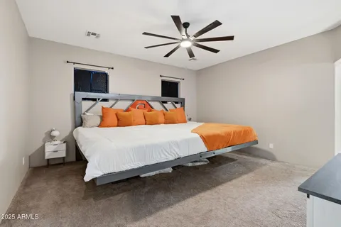 a bedroom with a bed and a chandelier