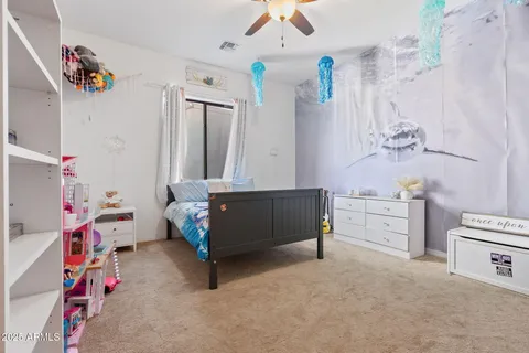 a living room with furniture and a baby crib