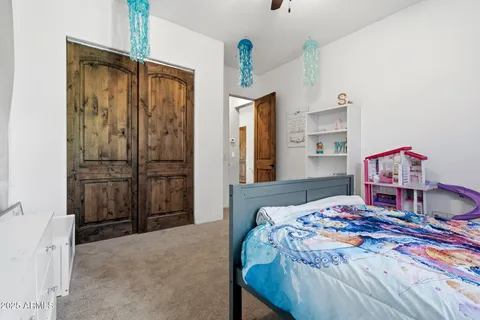 a bedroom with a bed and a dresser