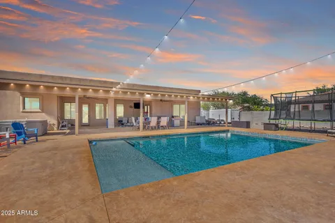 a view of a swimming pool and a back yard
