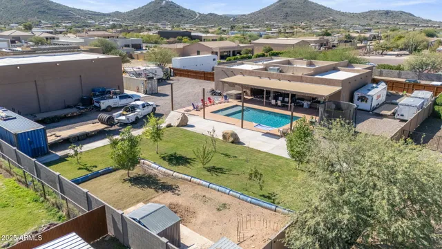an aerial view of a house with a mountain