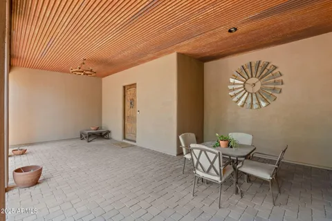 a dining room with furniture and a chandelier