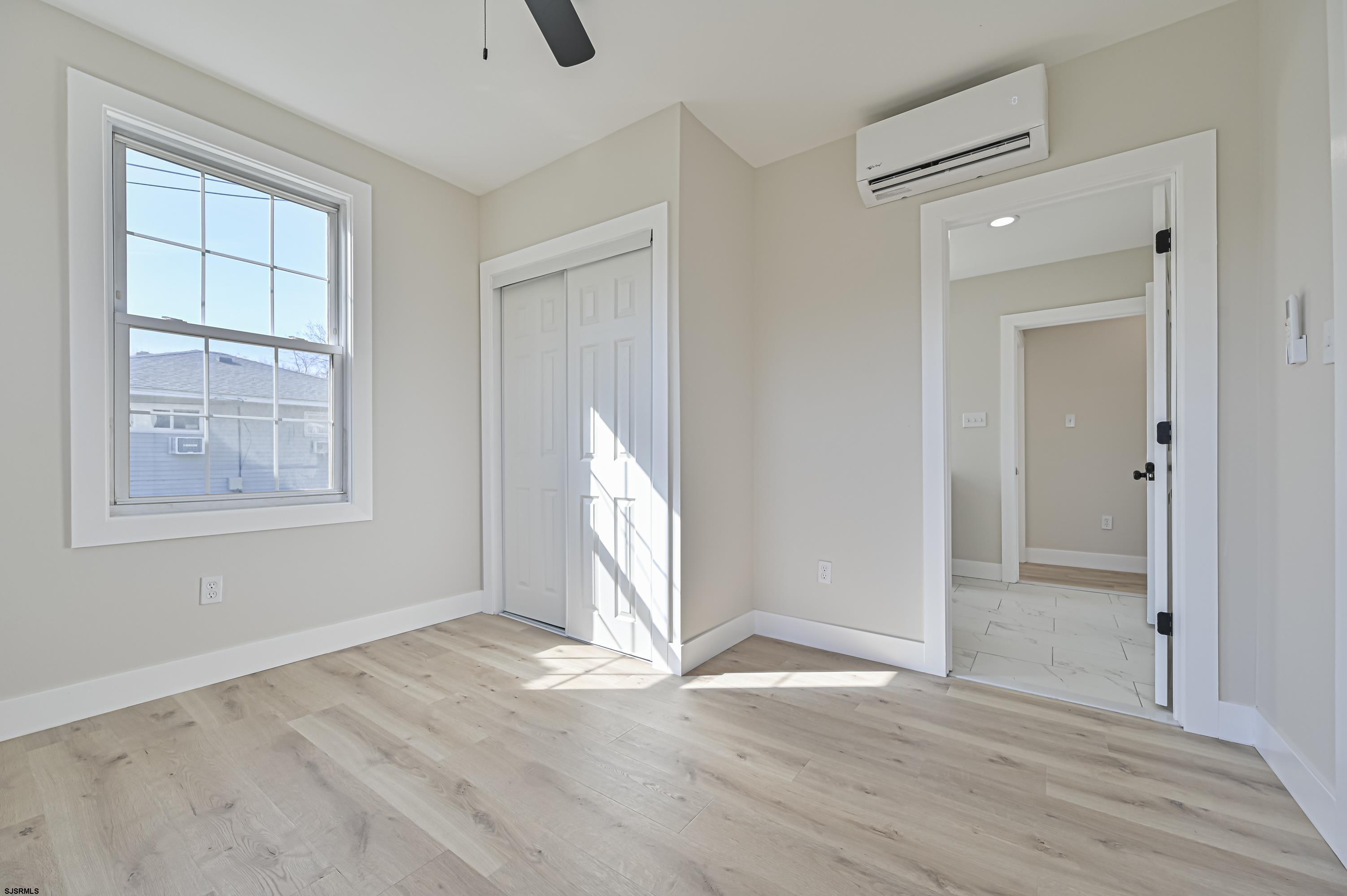 5906 Gaskill Street Mays Landing, NJ 08330 - Photo 20 of 39 an empty room with wooden floor and windows