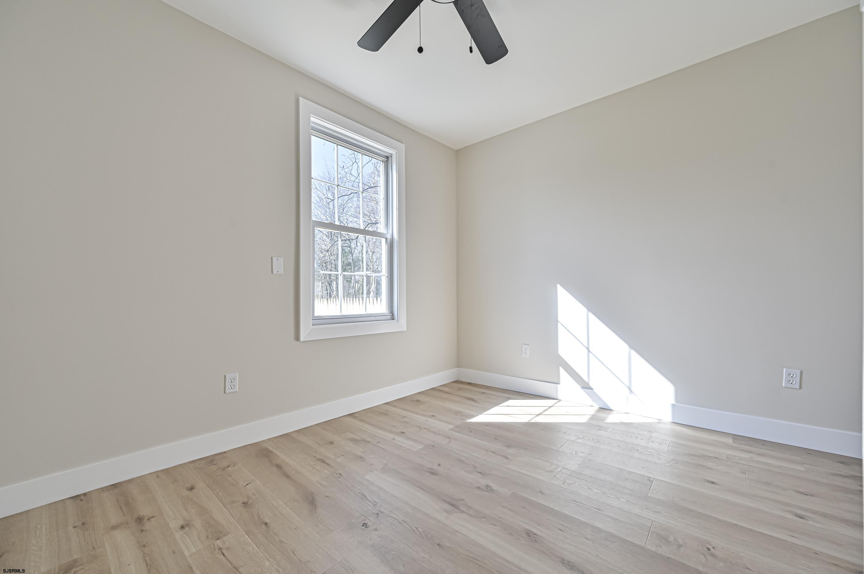 5906 Gaskill Street Mays Landing, NJ 08330 - Photo 24 of 39 an empty room with wooden floor closet and windows