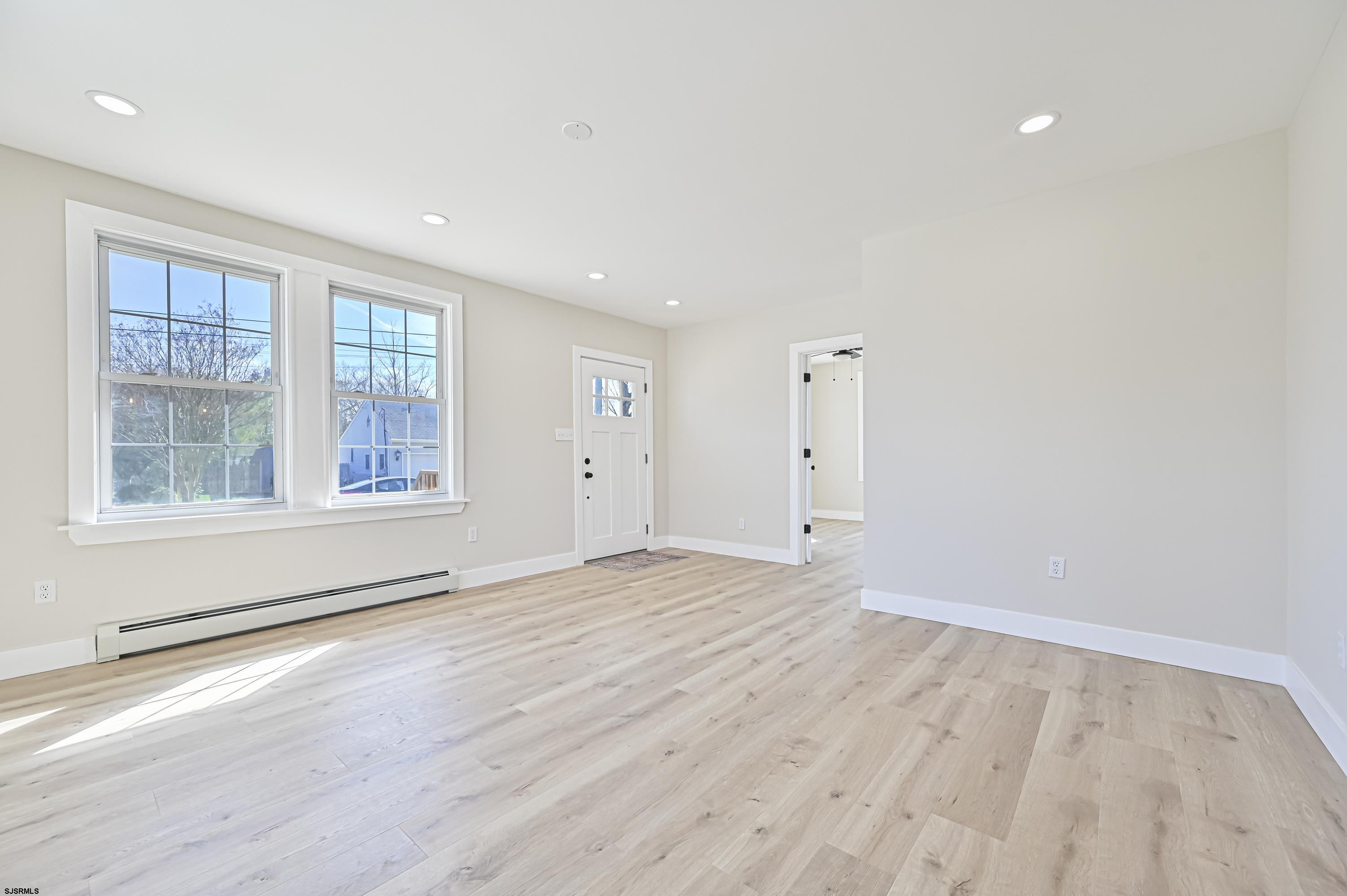 5906 Gaskill Street Mays Landing, NJ 08330 - Photo 8 of 39 a view of an empty room with a window and wooden floor