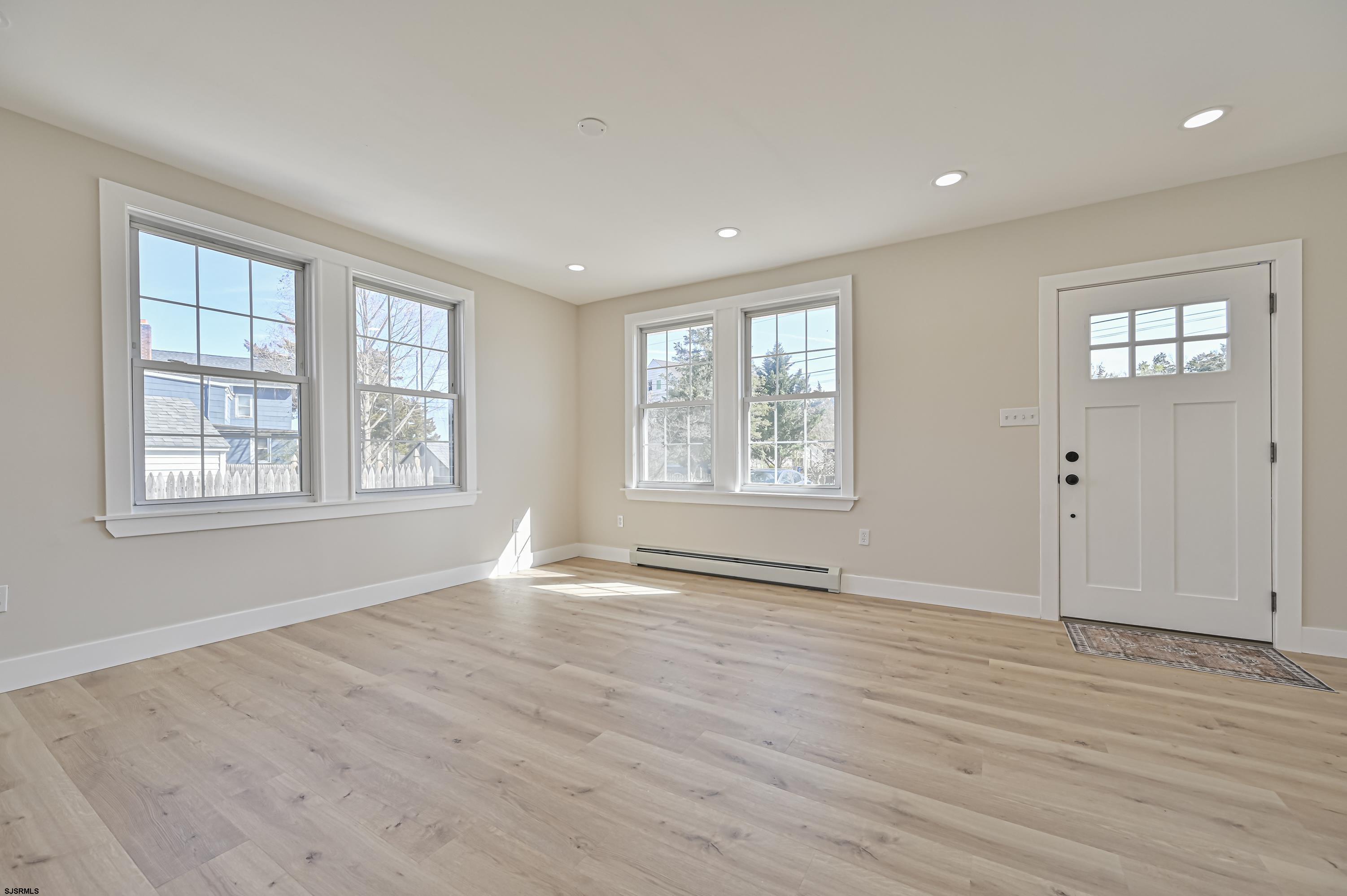 5906 Gaskill Street Mays Landing, NJ 08330 - Photo 9 of 39 an empty room with wooden floor and windows