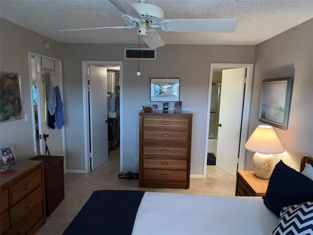 a bedroom with a bed and a desk