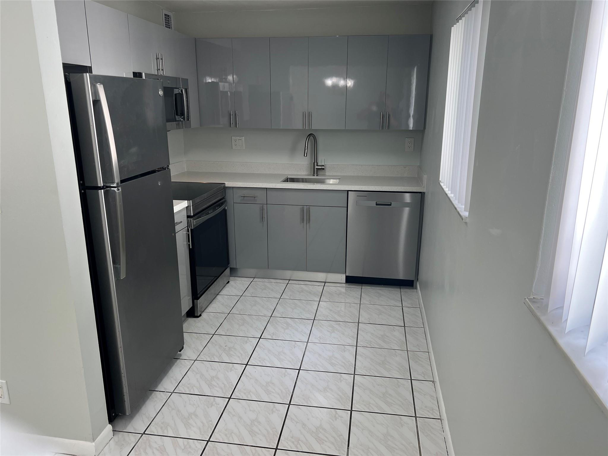 9920 Northwest 68th Place, Unit 210 Tamarac, FL 33321 - Photo 6 of 26 REMODELLED KITCHEN