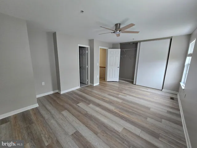 a view of a livingroom with wooden floor and window