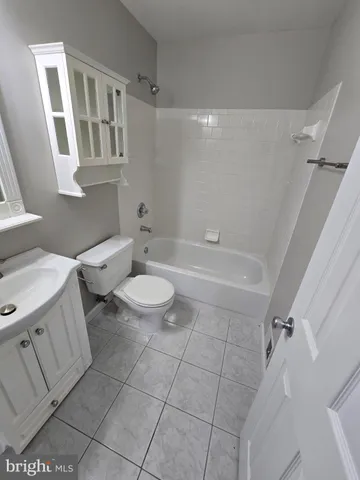 a bathroom with a toilet a sink and bathtub