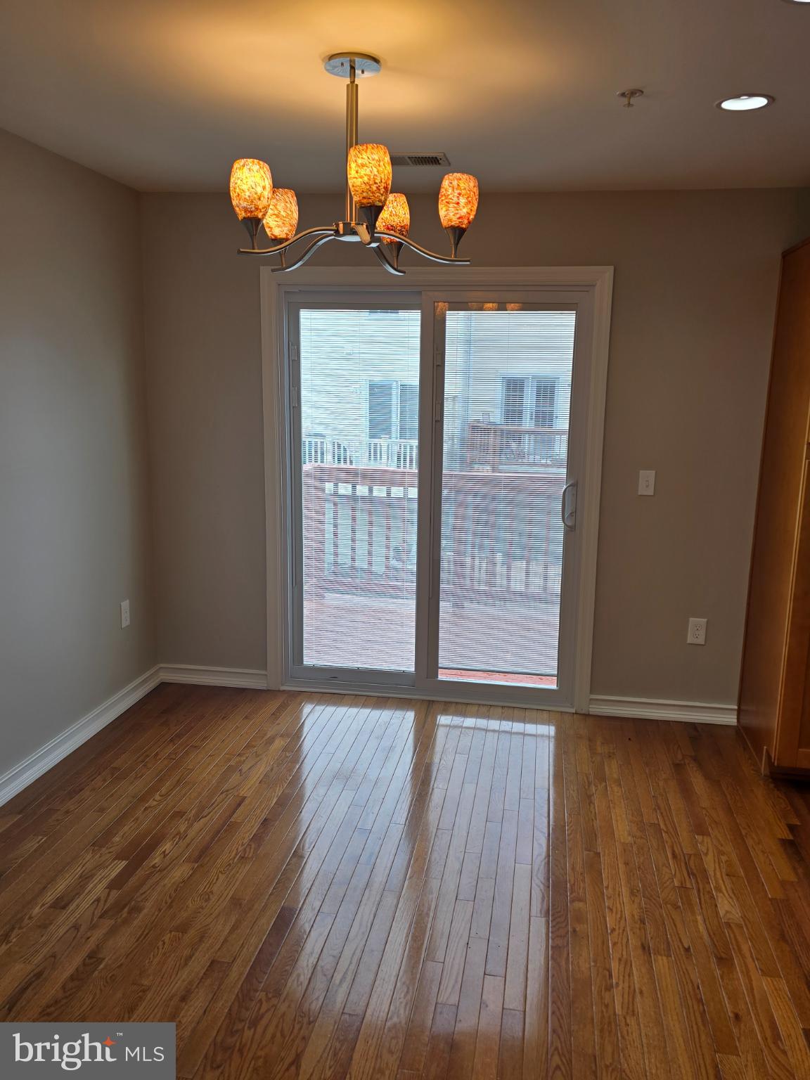 1105 Simsbury Court Crofton, MD 21114 - Photo 3 of 15 a view of an empty room with wooden floor and a window