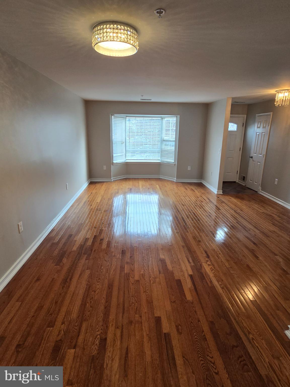 1105 Simsbury Court Crofton, MD 21114 - Photo 6 of 15 wooden floor in an empty room with a window