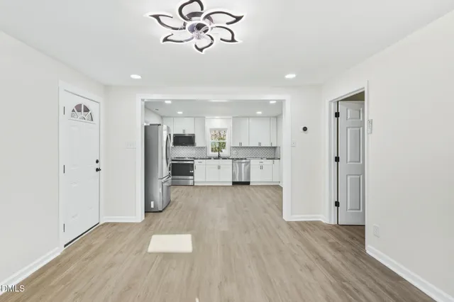 a view of a kitchen with a sink and wooden floor