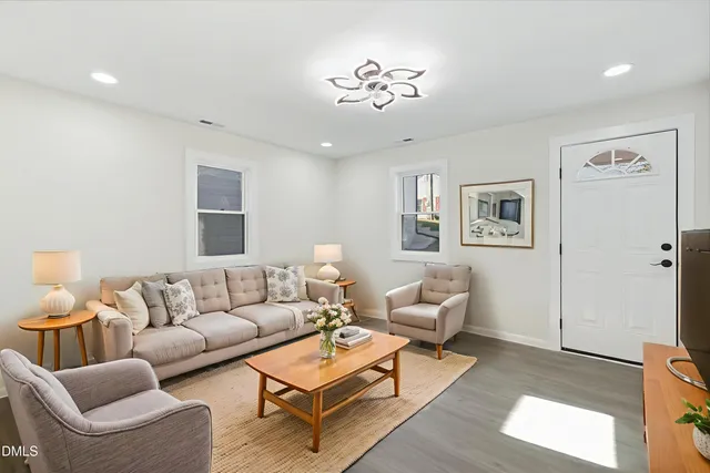 a living room with furniture and wooden floor
