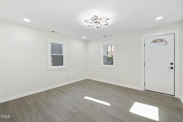wooden floor in an empty room with a window