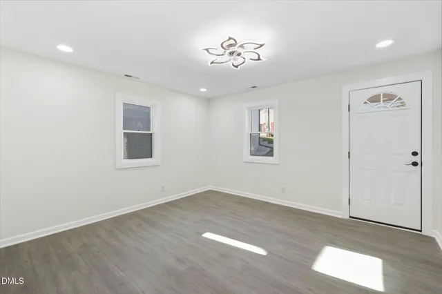 wooden floor in an empty room with a window