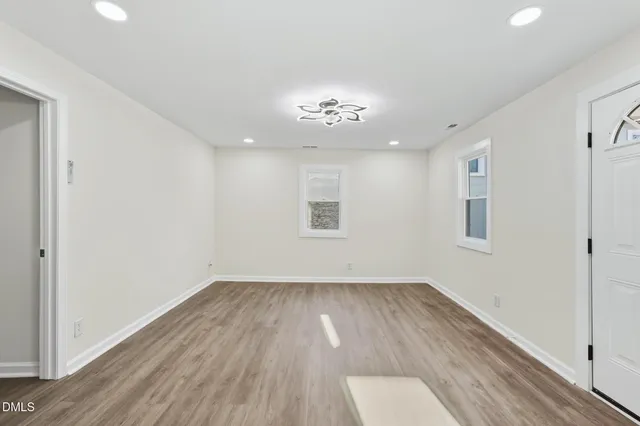 wooden floor in an empty room with a window