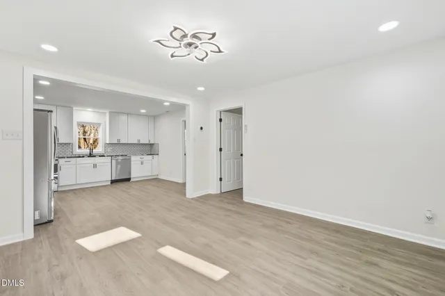 a view of a kitchen with a sink and a refrigerator