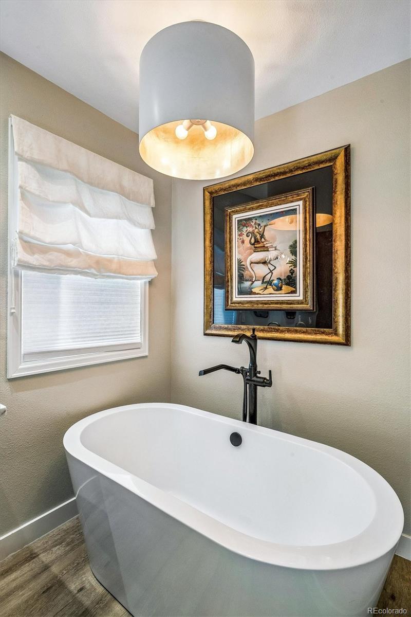 155 South Jackson Street, Unit A Denver, CO 80209 - Photo 18 of 40 a bathroom with a bathtub and a window