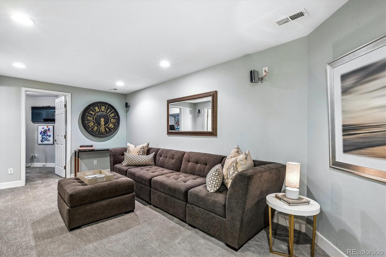 155 South Jackson Street, Unit A Denver, CO 80209 - Photo 23 of 40 a living room with furniture a clock and a window