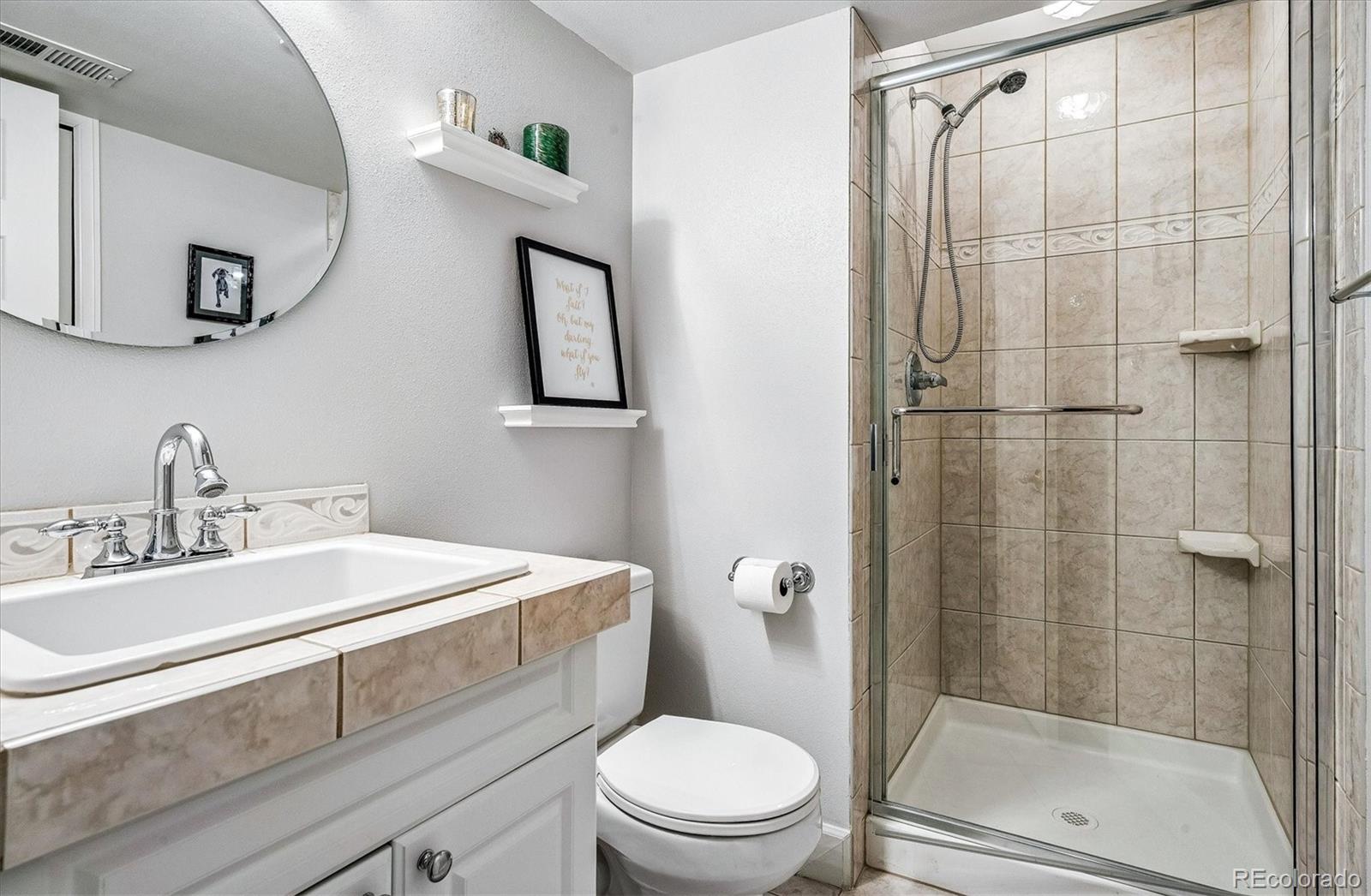 155 South Jackson Street, Unit A Denver, CO 80209 - Photo 27 of 40 a bathroom with a sink toilet and shower